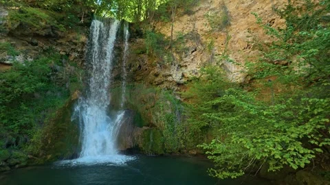 Water cascades down rocky cliff into serene pool. Veliki Buk, Serbia. Stock-Footage 336888965