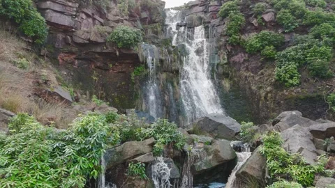 Water cascades down rugged, mossy rocks 库存影片 342940247