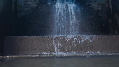 Water cascading down a concrete irrigation weir gate. Stock Footage 337768309