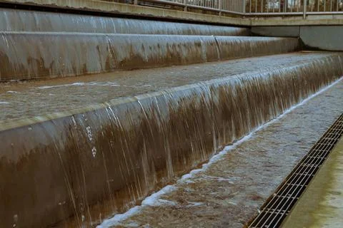 Water cascading down concrete steps at a water treatment facility Stock Photos