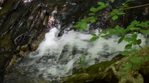 WATER CASCADING DOWN A ROCK IN A SMALL STREAM Stock Footage 132455216