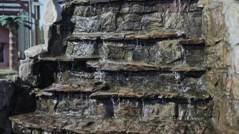 Water Cascading Down a Tiered Stone Fountain Outdoors Stock Footage 347054997