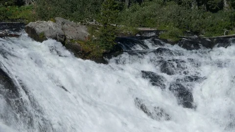 Water cascading down from the top of the Lewis Falls, Wyoming. Stock Footage 112773645