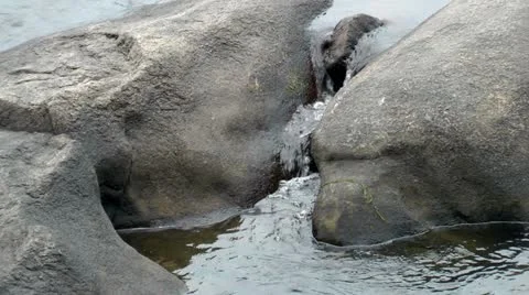 Water cascading over and between rocks - hd -1920x1080 Stock Footage 11060143