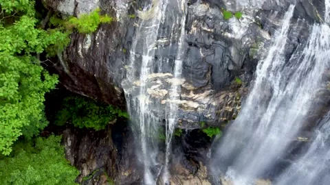 Water cascading over broad roack face Stock Footage 158323867