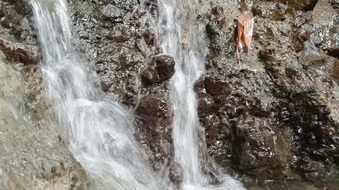 Water Cascading Over Dark Rocky Surface Close Up Nature Texture Stock Footage 329783315