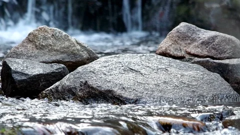 Water cascading over a rock in a stream Video stock 128236901