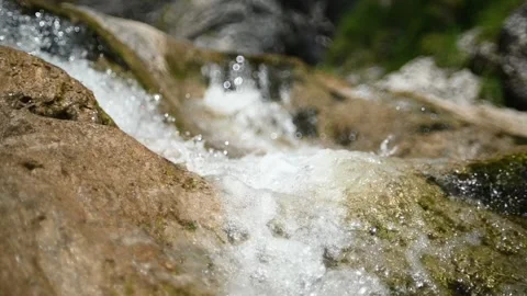 Water cascading over rocks in summer (slow motion) Video stock 219635364