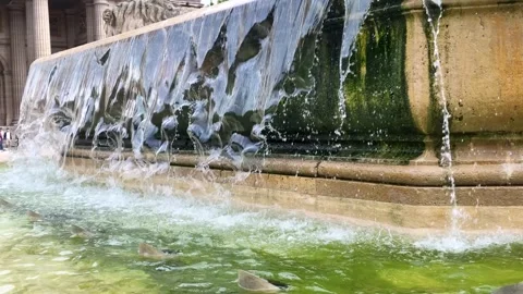 Water Cascading Over Stone Basin of Historical Fountain in Paris Stock Footage 336426760