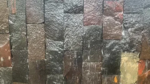 Water Cascading Over Textured Stone Wall Video stock 287994576