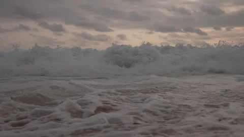 Water cascading over a tropical beach in slow motion Stock Footage 241522898