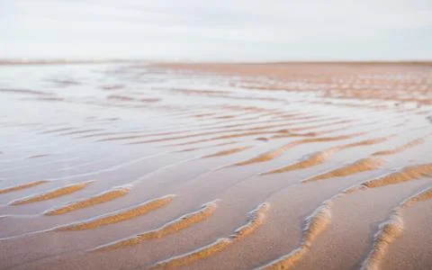 Water caught between sandy ripples Stock Photos