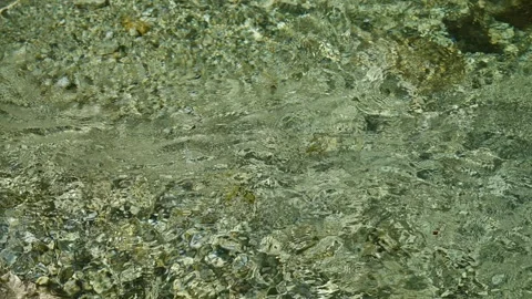 Water caustic light effect on clear mountain river surface, 4K slow motion Stock Footage 322992721