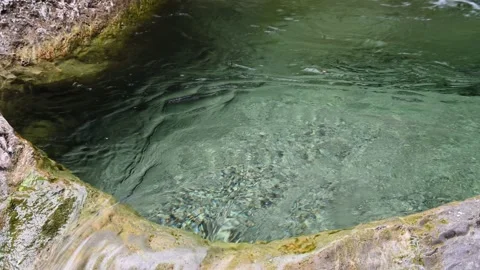 Water from a clean mountain stream is flowing out of a pool Stock-Footage 211466961