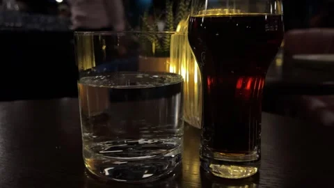 Water cola in a dark restaurant Big Glass Of Cola On A Terrace Table In A Stock Footage 292971801