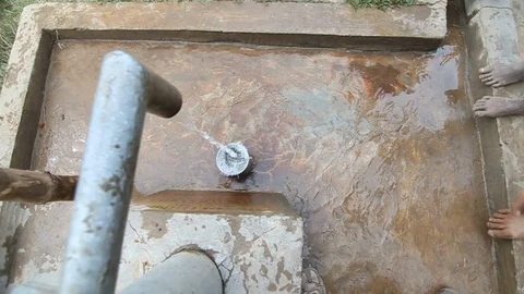 Water Comes Out Of Hand Pump Into Bucket In India Slow Motion Stock-Footage 102148983