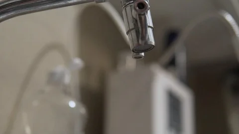 Water coming out faucet in slow mo Stock Footage