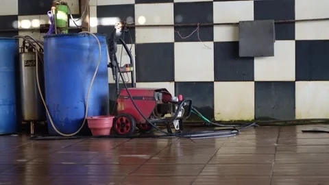 The water compressor at the car wash is close to a barrel filled with water Stock Footage 277437798