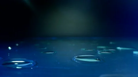 Water concept. on the glass surface with blue loght and many drops on the table Stock Footage 143374701