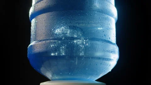 Water cooler on black background. Close-up of big plastic bottle, drinking in Stock Footage 175805630