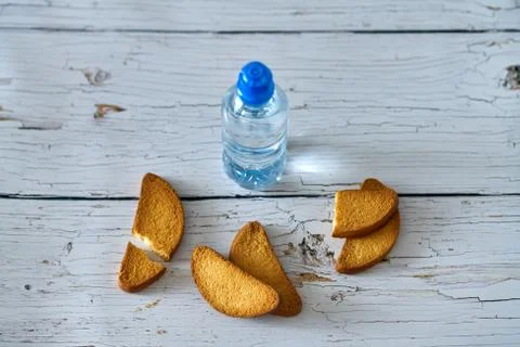 Water, crackers and drying on the background of boards. Stock Photos