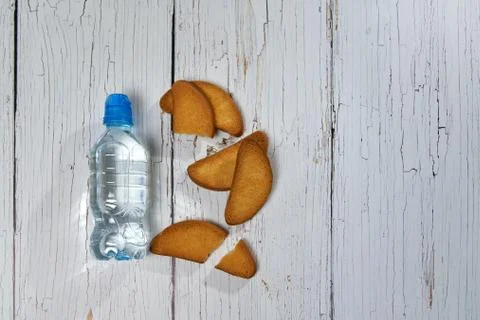 Water, crackers and drying on the background of boards. Stock Photos