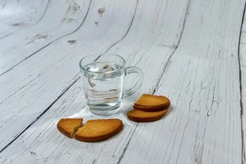 Water, crackers and drying on the background of boards. Stock Photos