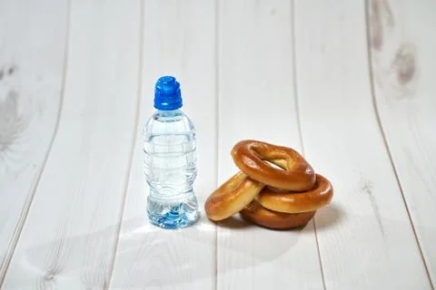 Water, crackers and drying on the background of boards. Stock Photos