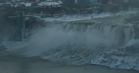 Water crashing down from Niagara waterfall on the American side winter Stock Footage 229598906