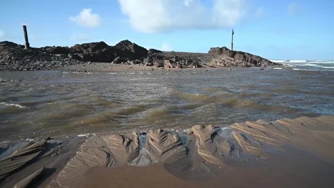 Water cutting through the soft sand on Bude beach Stock Footage 302990593