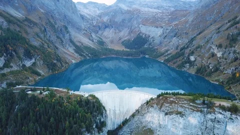 Water dam and reservoir lake aerial drone footage in Swiss Alps Stock Footage