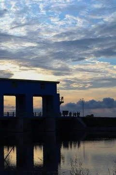 Water Dam Structure Reflected in Water Under Cloudy Sky Stock-Fotos
