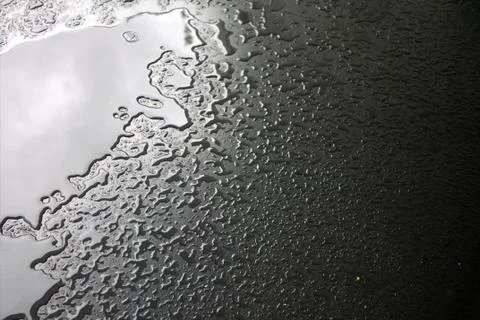 Water on a dark background. Stock Photos