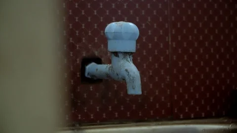 Water dipping down from tap closing with hands pollution wastage close up 4k Stock Footage 123725207