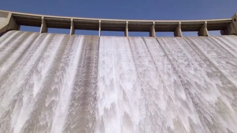Water discharge from the upper section of a gravity dam. Dam in operation Video stock 340918507
