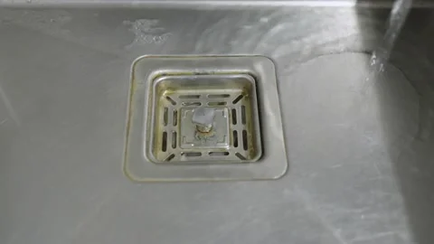 Water down a sink drain. Streaming water in sink. Stock Footage 232294986