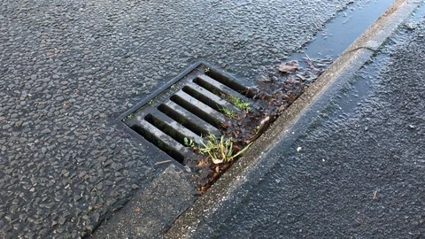 Water drain on the roadside Stock Footage 121420672