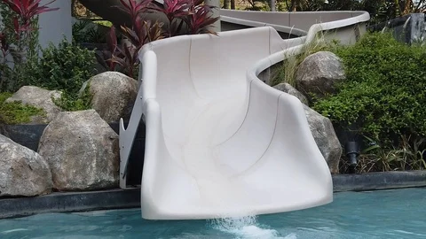  the water is drained from the water slide into the pool, Vidéo 104849308