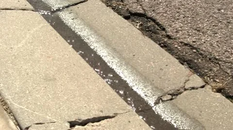 Water draining down street drain Stock Footage 10890697