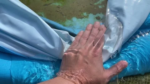 Water draining out of inflatable pool Stock Footage 344838571