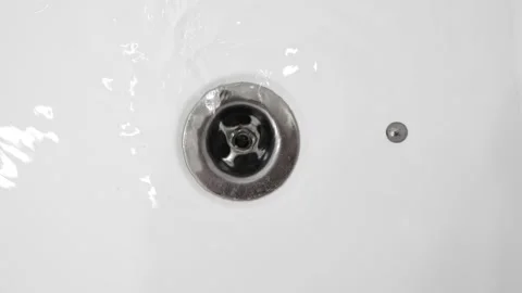Water drains into the sink in bathroom. Stock Footage 131086593