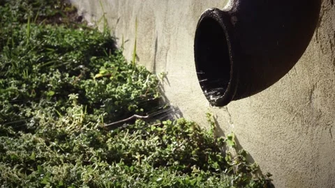 Water dripping down by the gutter. rain water streaming on the ground, natural  Stock Footage 166947120