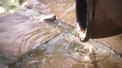 Water dripping down by the gutter. rain water streaming on the ground, natural  Stock Footage 166947394