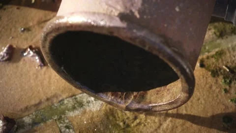 Water dripping down by the gutter. rain water streaming on the ground, natural  Stock Footage 166947417