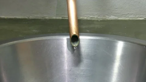 Water dripping fast from copper pipe Stock Footage 312206194
