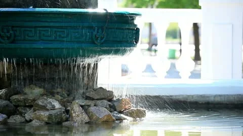 The water dripping from a fountain in a sunlight Stock Footage