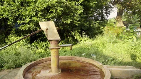 Water Dripping from hand pump in India - water problem, water crisis Stock Footage 162079201