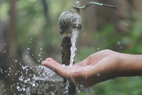 Water dripping on hands Stock Photos