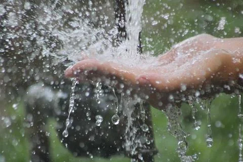 Water dripping on hands Stock Photos
