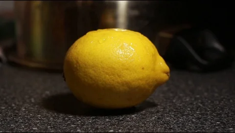 Water dripping on a lemon. Slow motion Stock Footage 111180482